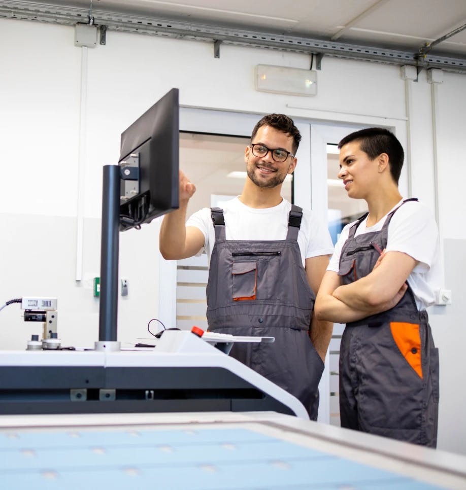 2 people looking at a computer monitor